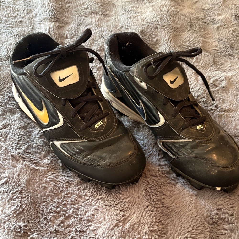 Nike Black and White Cleats with Gold Accent